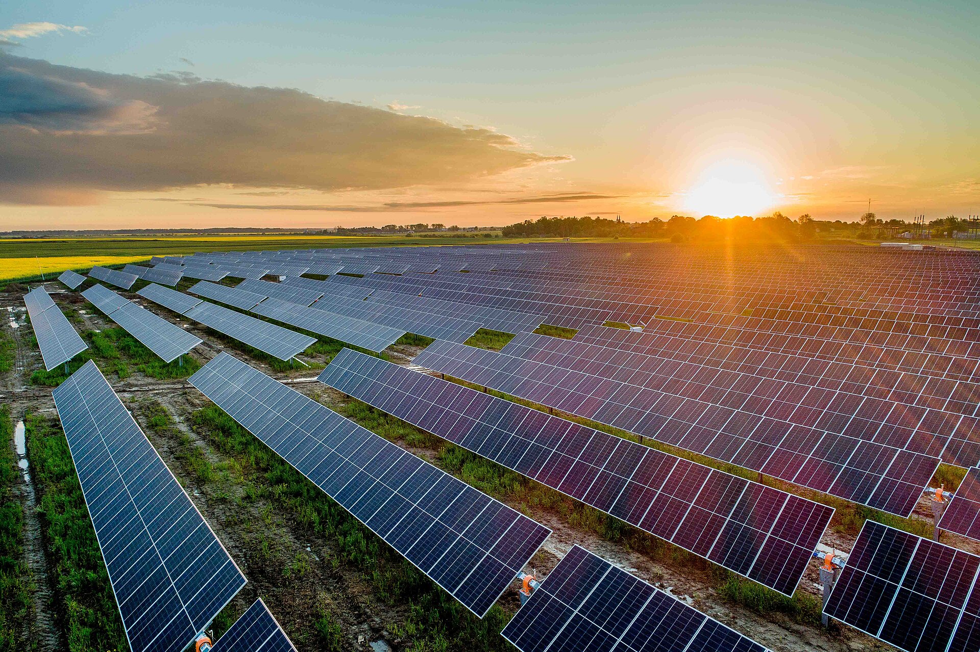 Aerial view of a large solar photovoltaic power plant at sunset