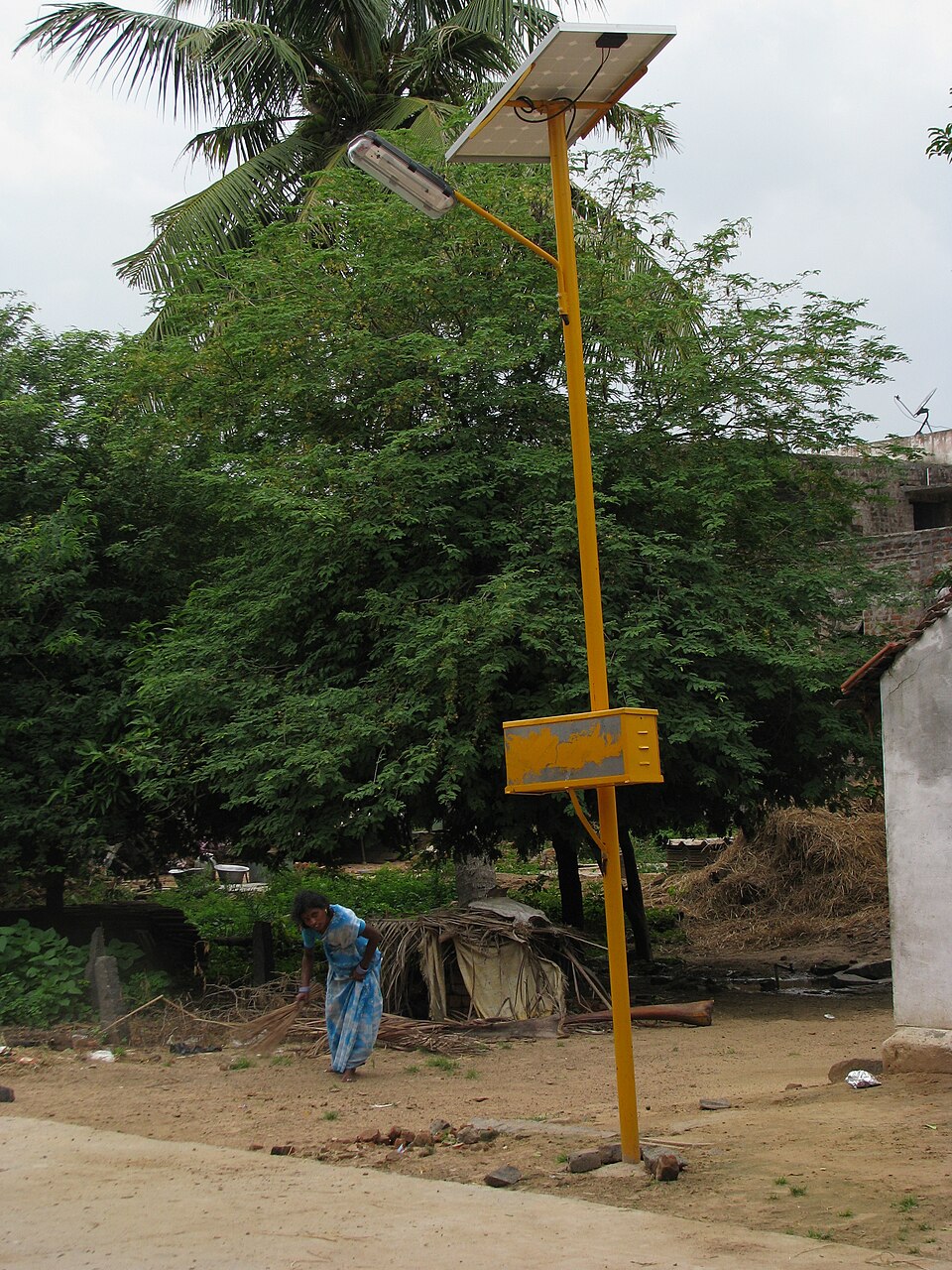 Solar powered street light with photovoltaic panel in an Indian village